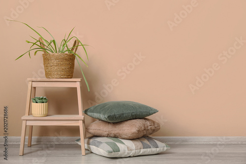 Schilderij op canvas Different cushions, stepladder and houseplants in living room