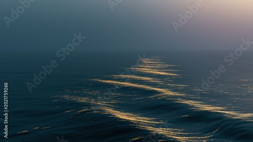 Golden light path shimmering on dark ocean waves at twilight in a serene misty seascape for wellness and meditation branding