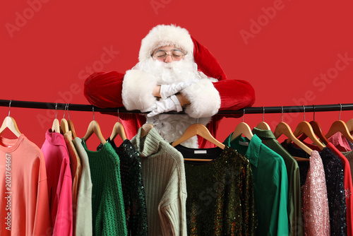 Santa Claus near rack with ...