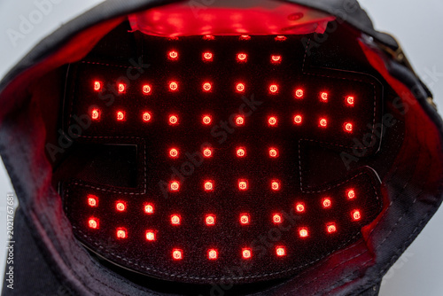 Close-up of a black red light therapy cap for hair growth, showcasing LED technology for scalp treatment and modern wellness care