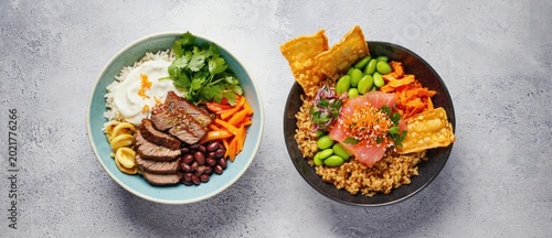 Delicious bowls of colorful fresh food with various ingredients on a light surface