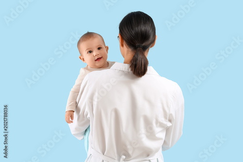 Female pediatrician holding...