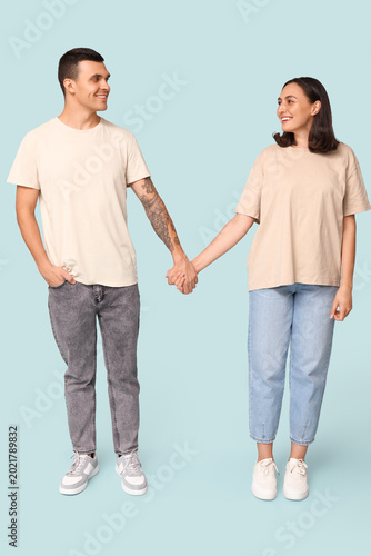 Young couple holding hands ...