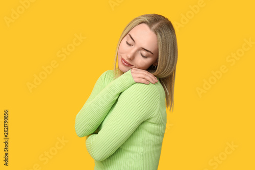 Young woman embracing herse...