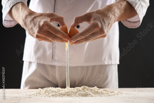 Young chef preparing dough ...