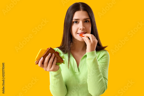Young woman eating tasty sa...