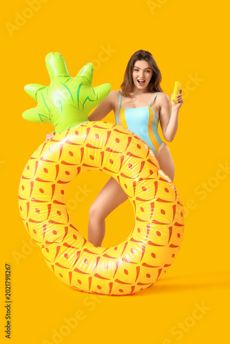 Young woman with swim ring ...