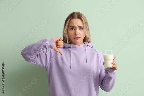 Upset young woman with glas...