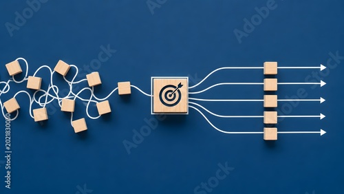Tangled string with scattered blocks passing through a target turning into straight arrows and aligned cubes representing process optimization and strategic business alignment