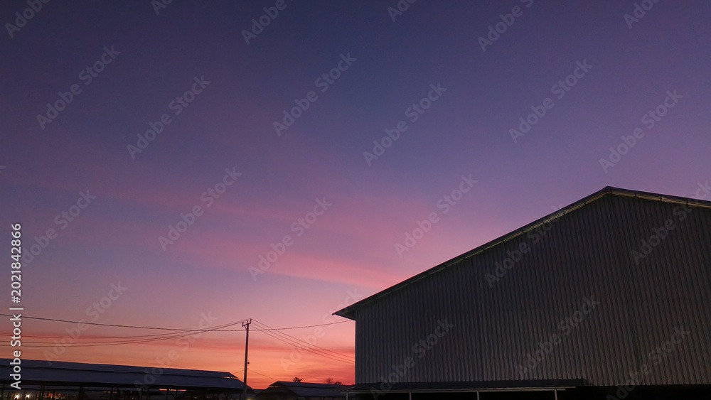 Fototapeta premium Buildings in the morning sky background with a purplish pink glow