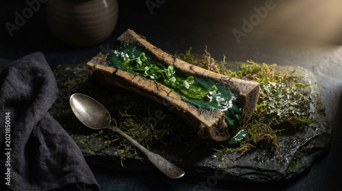 Emerald marrow in fossilized bone with glowing oil