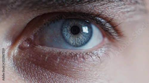 A captivating close-up of a vibrant blue human eye, showcasing the intricate patterns of the iris and the reflective pupil, conveying depth of vision and profound introspection