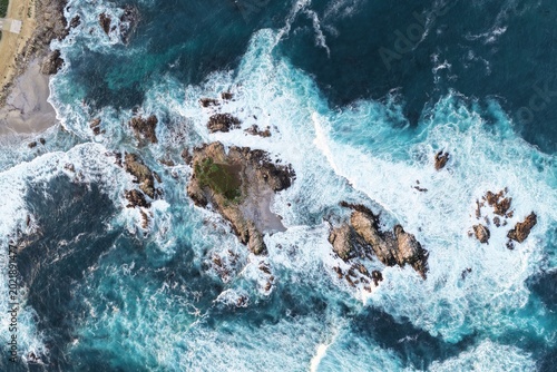 Εκτύπωση καμβά Aerial top view of rocky coastline with turquoise waves crashing near Monterey California USA