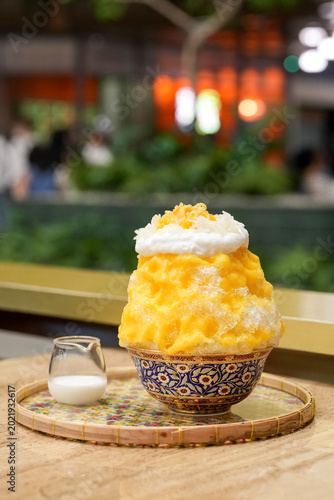 Photography Mango Sticky Rice Kakigori - Soft and fluffy shaved ice filled with fresh mango chunks, drizzled with juicy mango sauce, and topped with coconut cream, sweet sticky rice, and luscious fresh mango