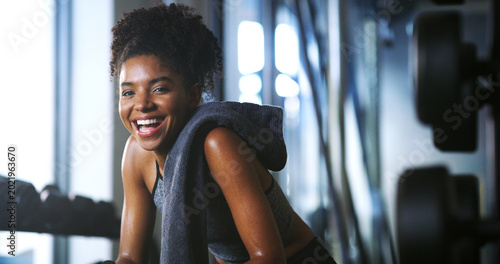 Photos Portrait, athlete and woman with smile at gym for wellness, fitness session and exercise recovery