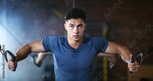 Tableau sur toile Fitness, man and cable weight machine in gym, workout and resilience training for strength challenge