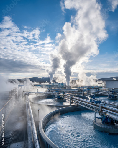 Industrial Water Facility With Steam Pipes And Cold Blue Sky