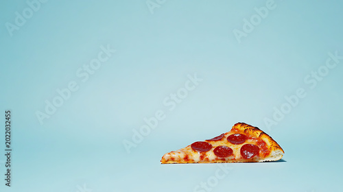 Delicious slice of pepperoni pizza on blue background perfect for food concepts