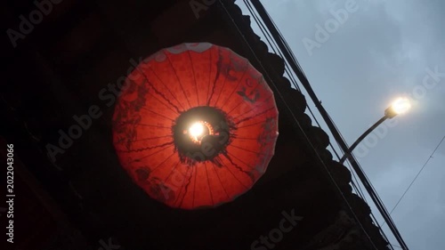 Red Traditional Lantern Illuminating an Evening sky with a Warm Cultural Glow, shot from low angle