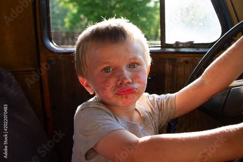 Close Up Of Dirty Child Playing In Old Truck