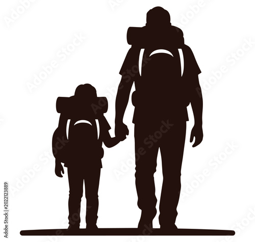 silhouette of adult and child with backpacks walking hand in hand outdoors