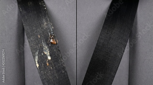 Dirty black seatbelt half cleaned showing before and after comparison.