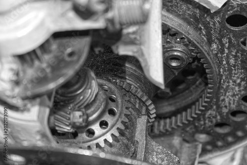 Close-up of complex interlocking metal gears in a heavy industrial engine. Mechanical engineering background