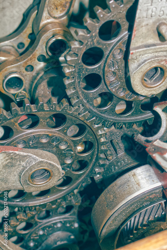 Detailed view of interlocking metal cogs and gears in a mechanical device. Industrial engineering