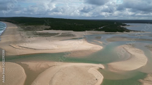 Aerial drone footage of Albufeira beach, Portugal: golden sand, Atlantic Ocean and Algarve cliffs under sunny skies. Ideal for travel, summer and coastal projects.