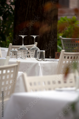 elegantly served outdoor tables in a restaurant, Italy
