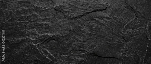 Panel kuchenny z motywem A rough-textured natural slate surface in deep gray and black tones. A natural stone texture with a rustic yet modern look, ideal as a backdrop for design projects.
