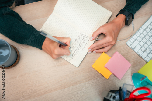Fotografie Young woman mindfully journaling and reflecting in her notebook, embracing self-