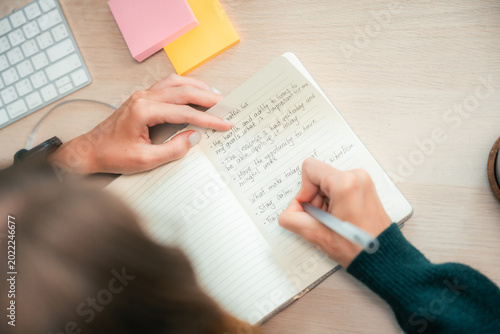 Photos Young woman mindfully journaling and reflecting in her notebook, embracing self-
