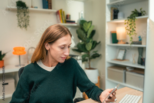 Modern woman using voice commands on her smartphone to interact with AI assistant app, efficiently managing her work schedule hands-free to stay productive and organized during a busy remote workday