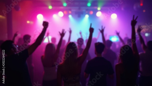 blurred colorful party lights with raised hands nightclub celebration background