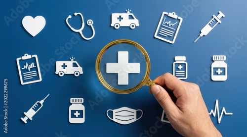 A hand examines medical icons with a magnifying glass on a blue background