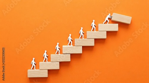 People climbing stairs made of blocks on orange background