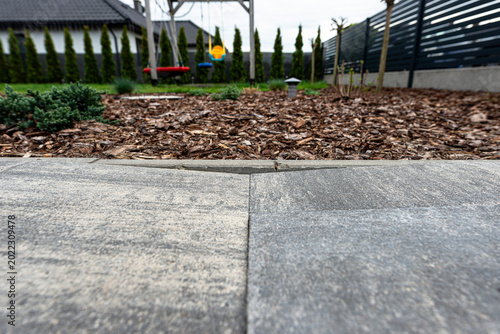 Uneven paving slabs showing ground subsidence in yard