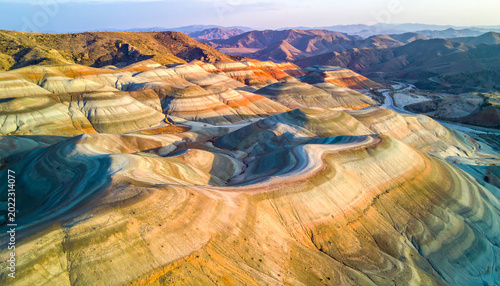 Aerial View of Vibrant Layered Rainbow Mountains