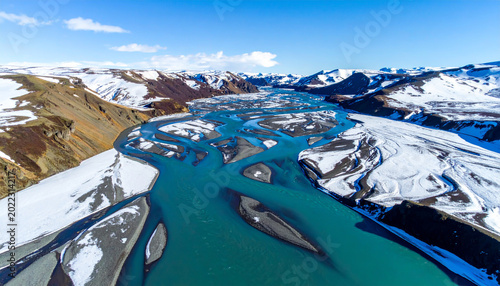 Aerial View of Braided Turquoise River in Snowy Mountains
