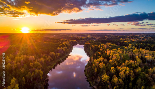 Aerial Sunset Over Autumn Forest and Reflective River