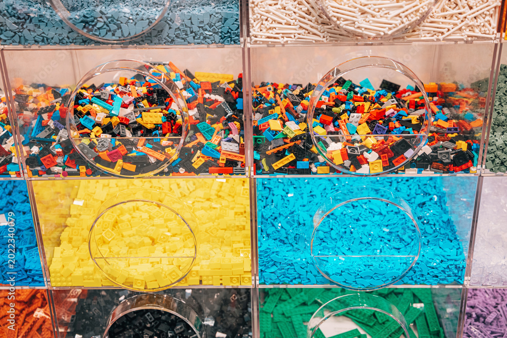 Obraz premium 19 October 2025, Belgrade, Serbia: Various colorful LEGO bricks sorting in plastic bins on a pick a brick wall creating a vibrant toy store display