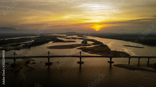 Tableau sur toile Golden hour aerial view over Cổ Lũy Bridge and the Quang Ngai estuary, Vietnam