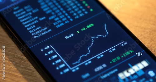 Schilderij op canvas Gold price up, rising chart on a smartphone screen, commodity trading