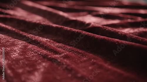 Textured red velvet fabric draped with elegant soft folds