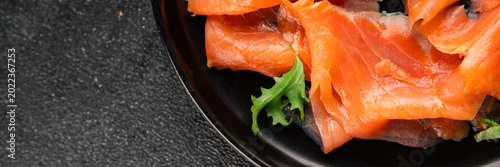 Salted salmon fresh seafood smoked red fish slices tasty snack fresh delicious gourmet food background on the table rustic food close-up copy space pescetarian diet