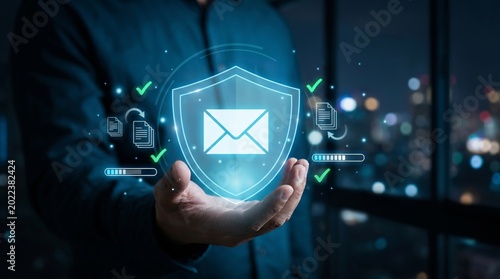 Advanced cybersecurity protecting email and data. A hand holds a glowing shield for secure digital communication