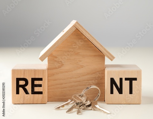 Wooden House Model with Rent Blocks and Keys, Property Concept.