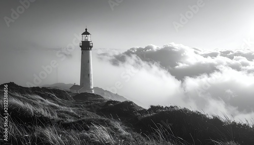 Solitary lighthouse stands tall against a cloudy sky, near grassy dunes