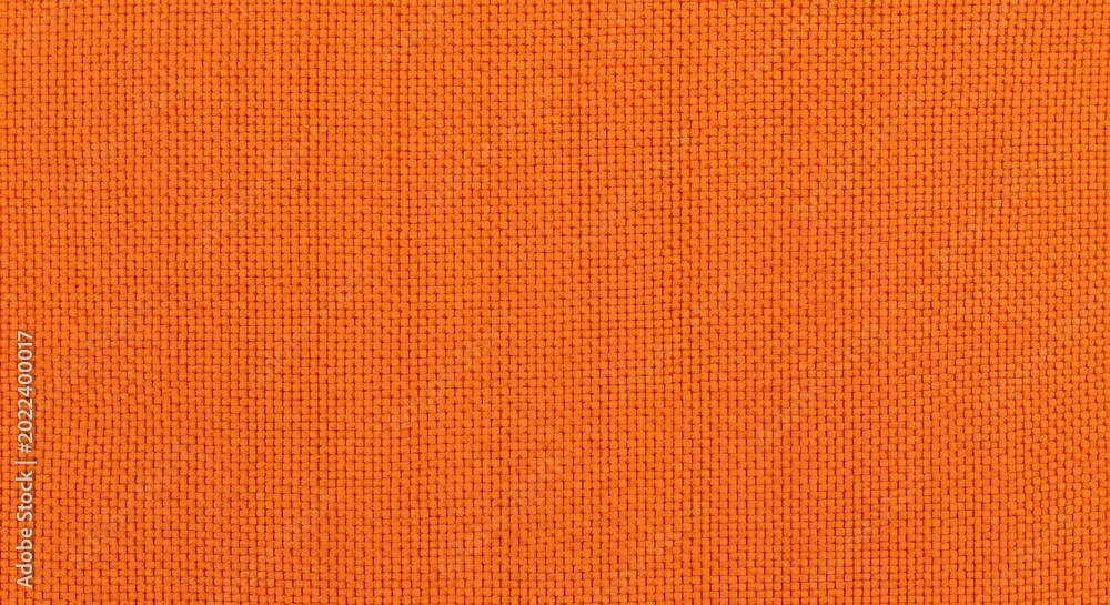 Fototapeta premium A textured background featuring a repeating pattern of small orange squares on an orange surface